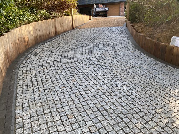 Granite block paved driveway with curved edging