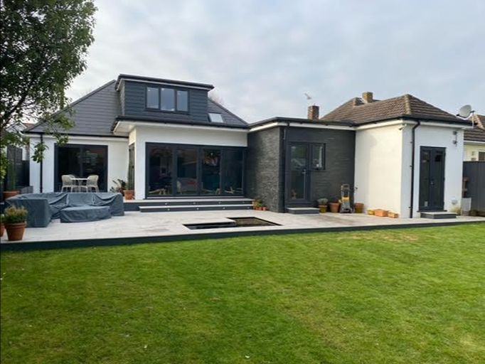 Landscaped garden with timber pergola, curved retaining walls and newly laid lawn