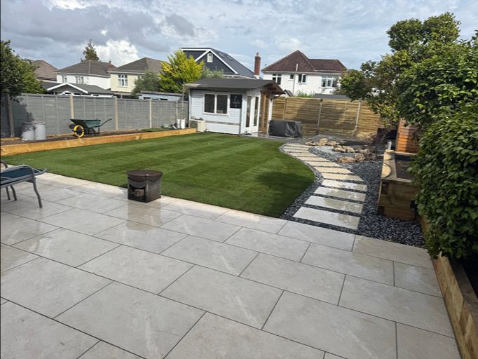 Landscaped garden with porcelain patio, lawn and stepping stone pathway